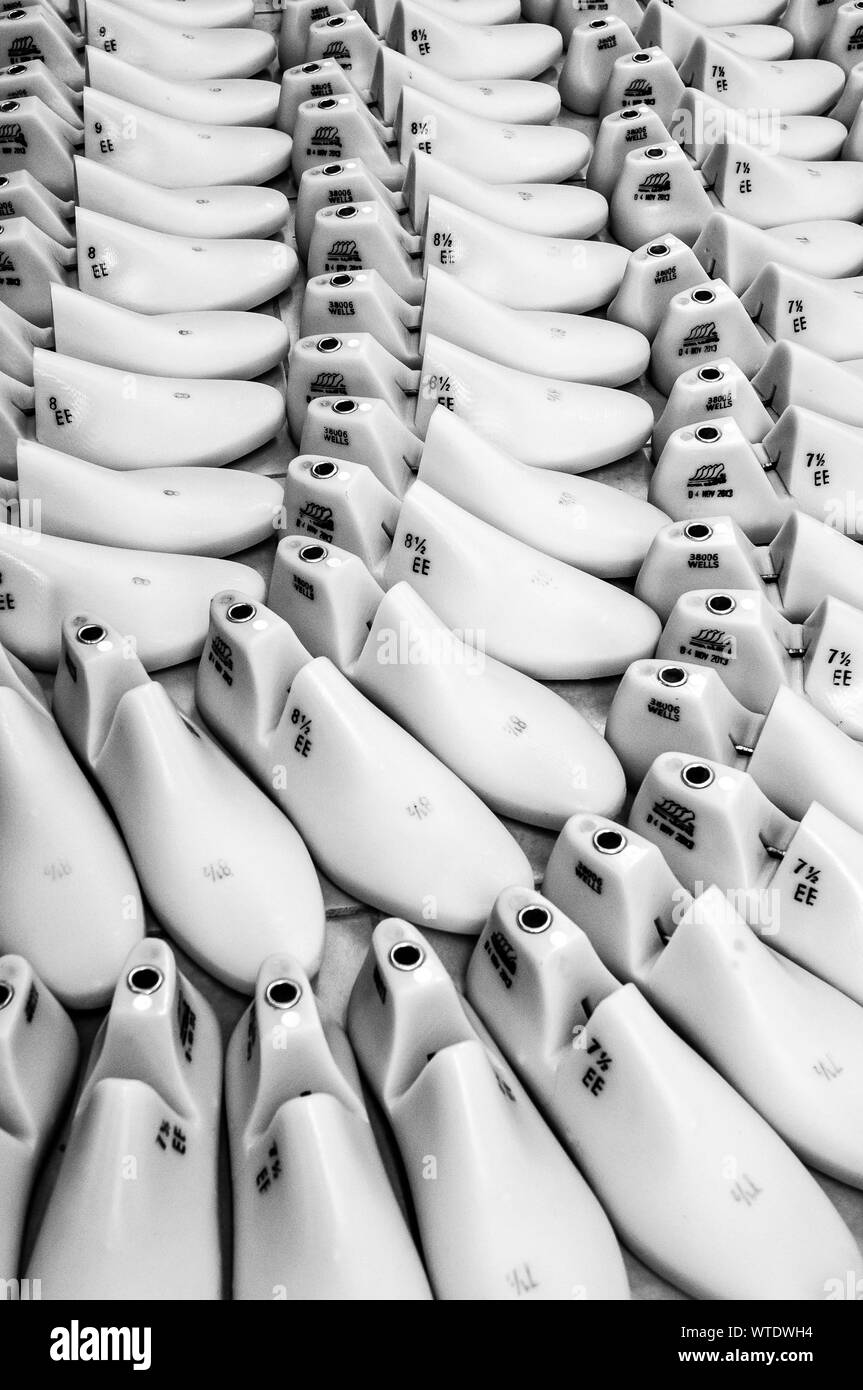rows of white plastic shoe lasts used to manufacture modern day shoes Stock Photo