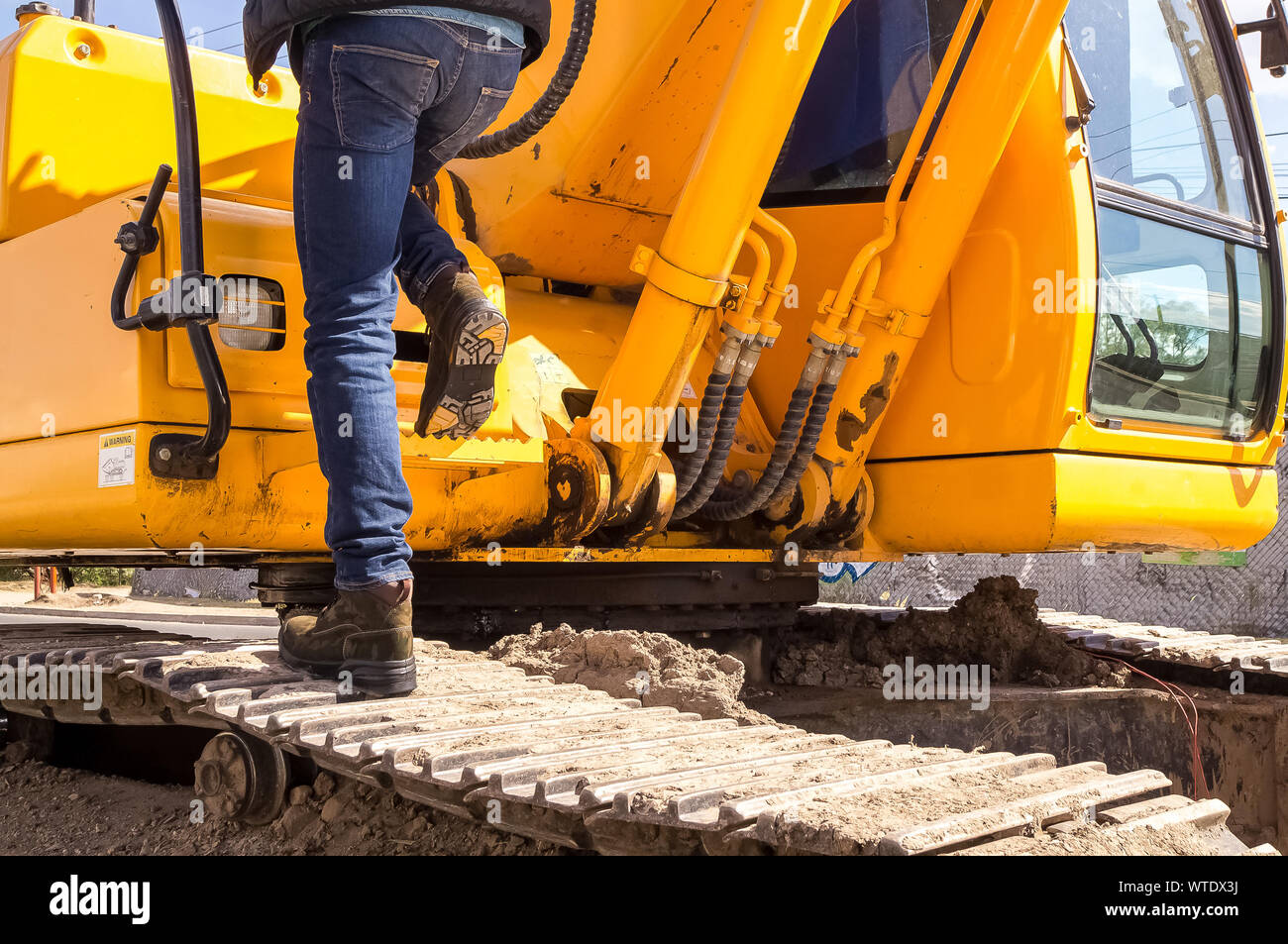 Construction worker wearing safety shoes with strong sole driving