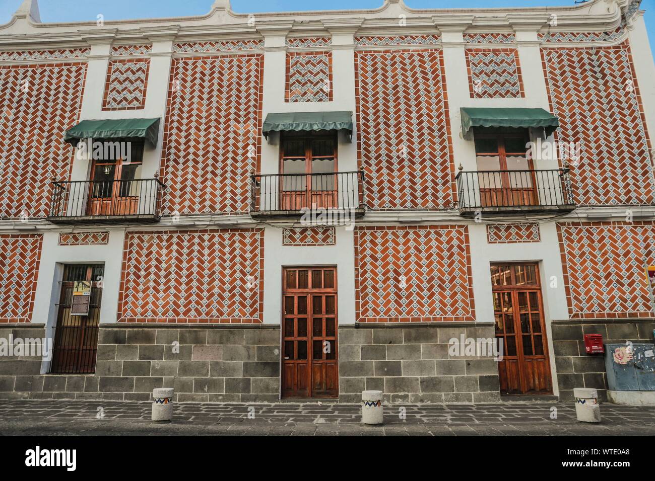 balconies, buildings and house in Puebla de Zaragoza, Mexico. Puebla has  Mexican traditions: gastronomic, colonial architecture and ceramics.  Painted talavera tiles adorn ancient buildings. The cathedral of Puebla, in  Renaissance style, has