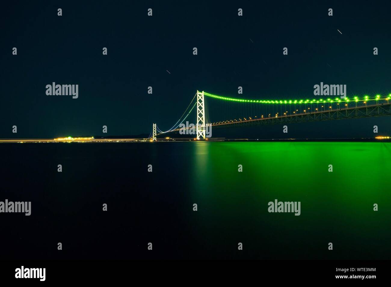 Illuminated Akashi Strait Bridge At Night Stock Photo