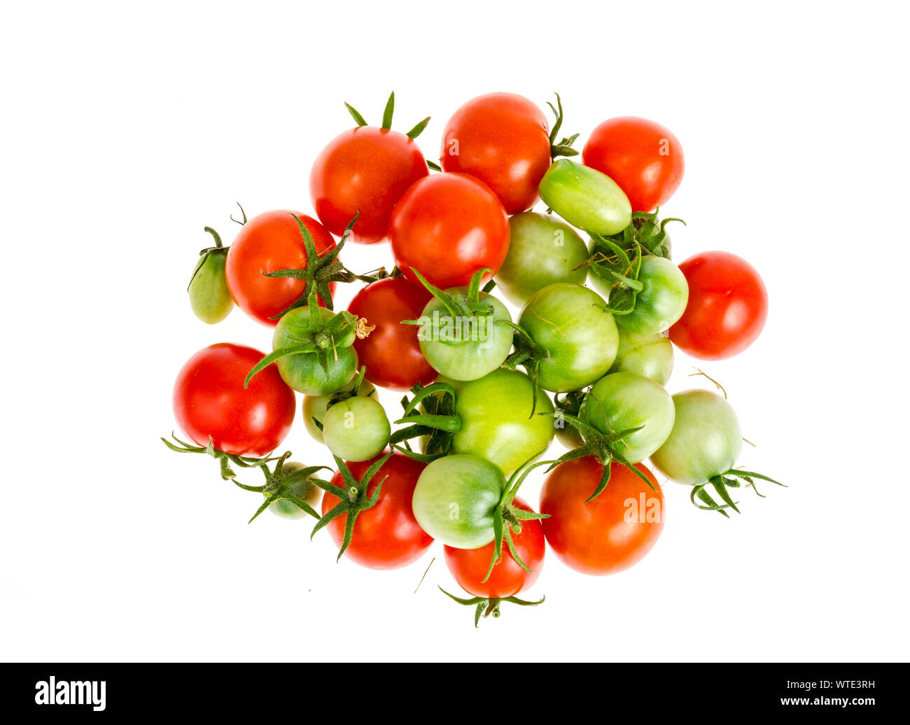Small bunch of ripe red and green unripe tomatoes isolated on white ...