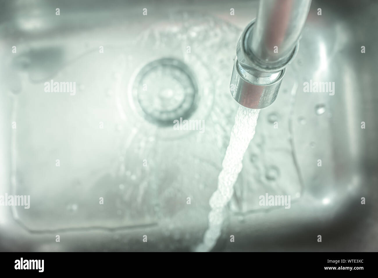 Open tap pouring water into the sink Stock Photo Alamy