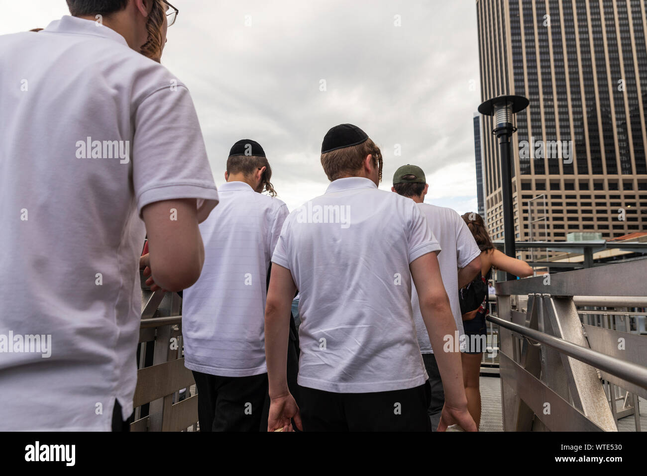 New York City, USA - August 2, 2018: Ultra-orthodox young Jews with kippah walking on a jetty in Manhattan, New York City, USA Stock Photo