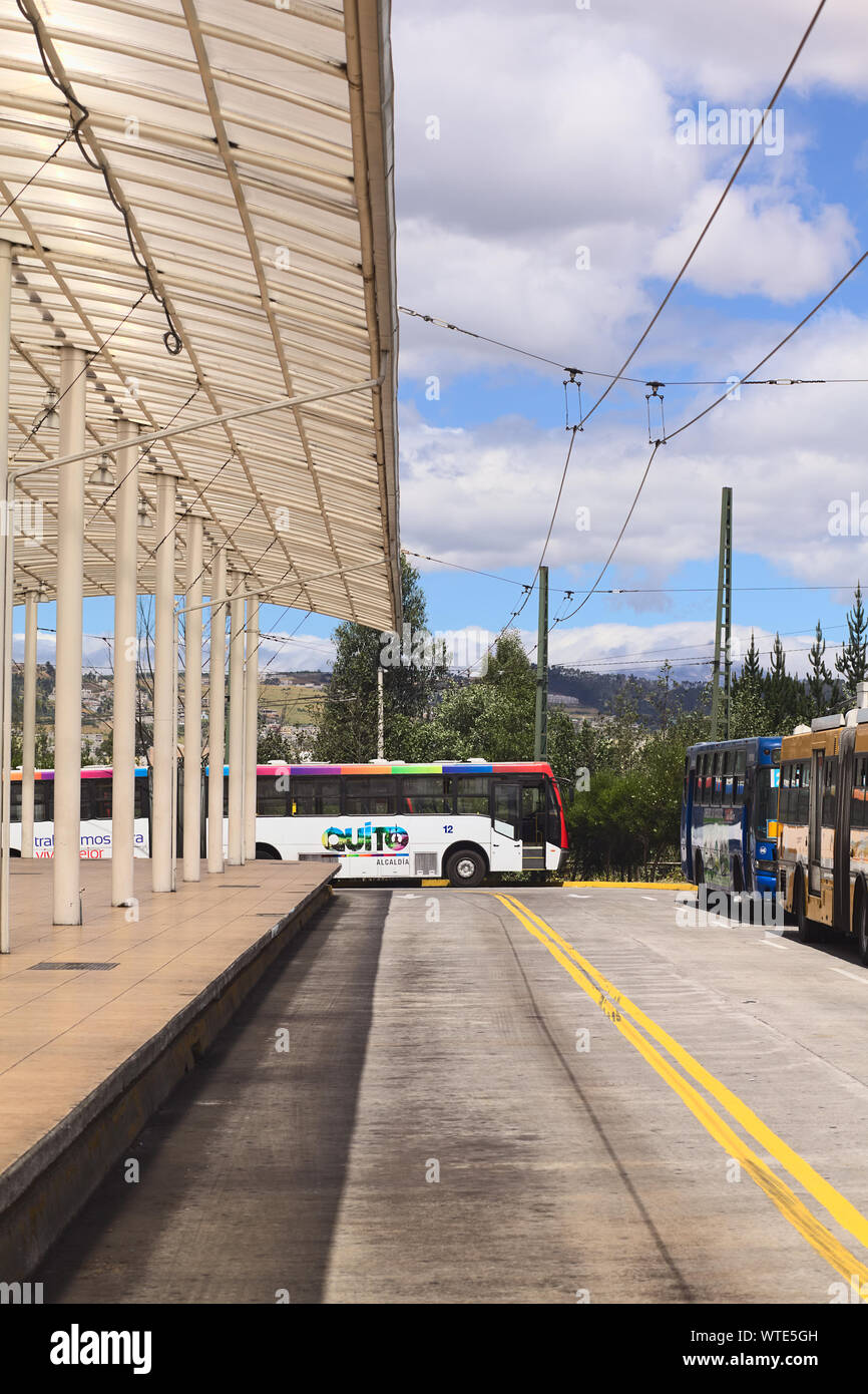 QUITO, ECUADOR - AUGUST 8, 2014: An empty local bus with Quito Alcaldia sign on it standing outside the Terminal Terrestre Quitumbe in Quito, Ecuador Stock Photo