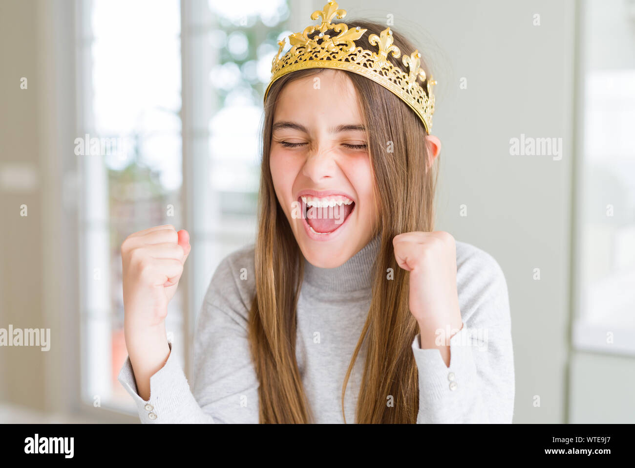 Beautiful young girl wearing a golden crown as a princess from ...