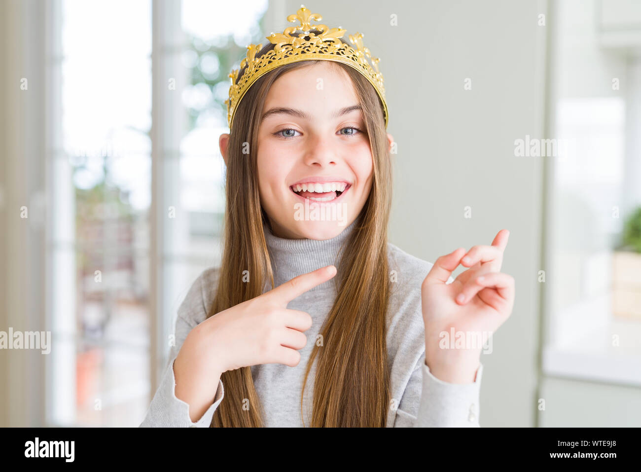 Beautiful young girl wearing a golden crown as a princess from ...