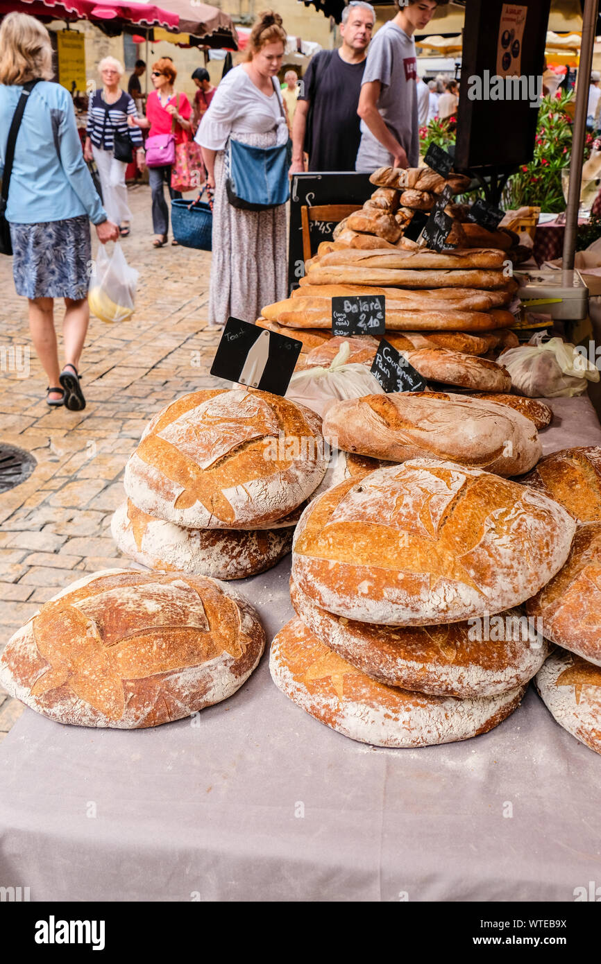 Stack of varieties of French breads on table in farmers market in
