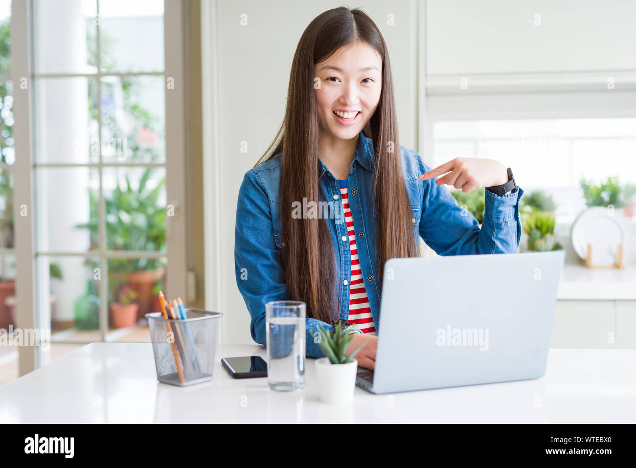 Beautiful Asian woman working using computer laptop with surprise face ...