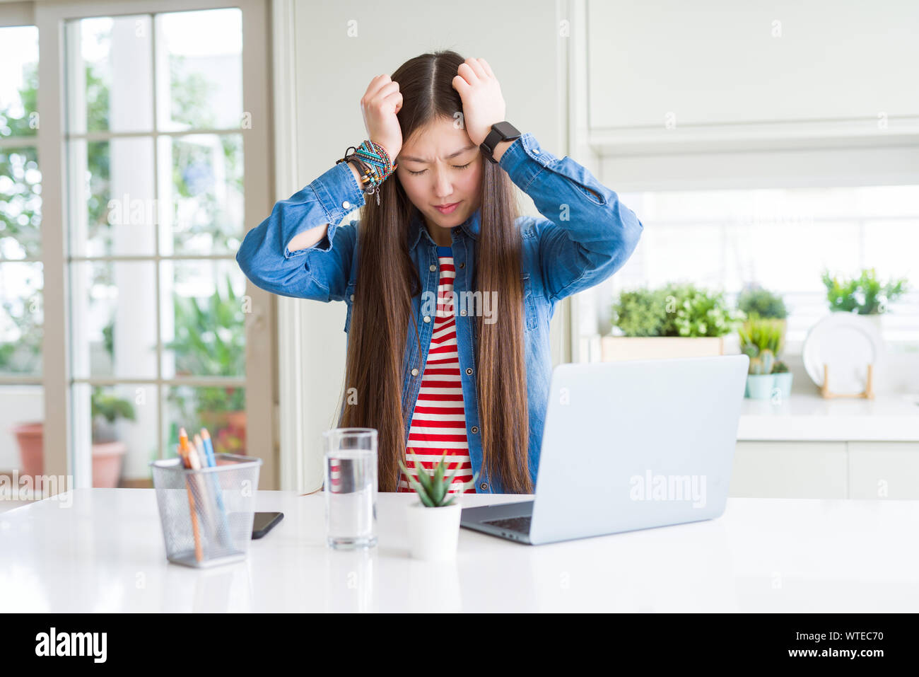 Beautiful Asian woman working using computer laptop suffering from ...