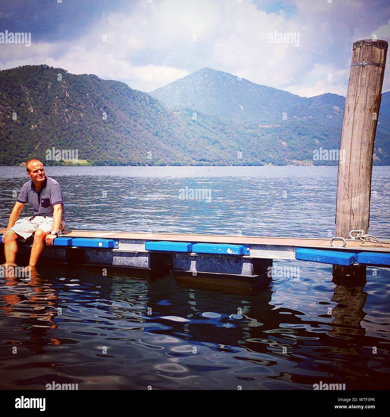 Relaxing on pier by mountain lake hi-res stock photography and images -  Alamy