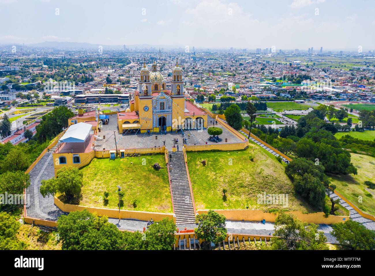 Aerial view of the Sanctuary of the Virgen de los Remedios in the Archaeological Zone of Cholula, Puebla, Mexico. Tlachihualtépetl. Puebla has Mexican traditions: gastronomic, colonial architecture and ceramics. Painted talavera tiles adorn ancient buildings. The cathedral of Puebla, in Renaissance style, has a high-rise bell tower overlooking the Zocalo, the central square or zocalo. I enter historical. Architecture is a UNESCO World Heritage Site. Attractions: Cathedral, Temple of Our Lady of Concord, Former Carolino College, Palafoxiana Library, Temple of Santo Domingo.  (© Photo: LuisGutie Stock Photo