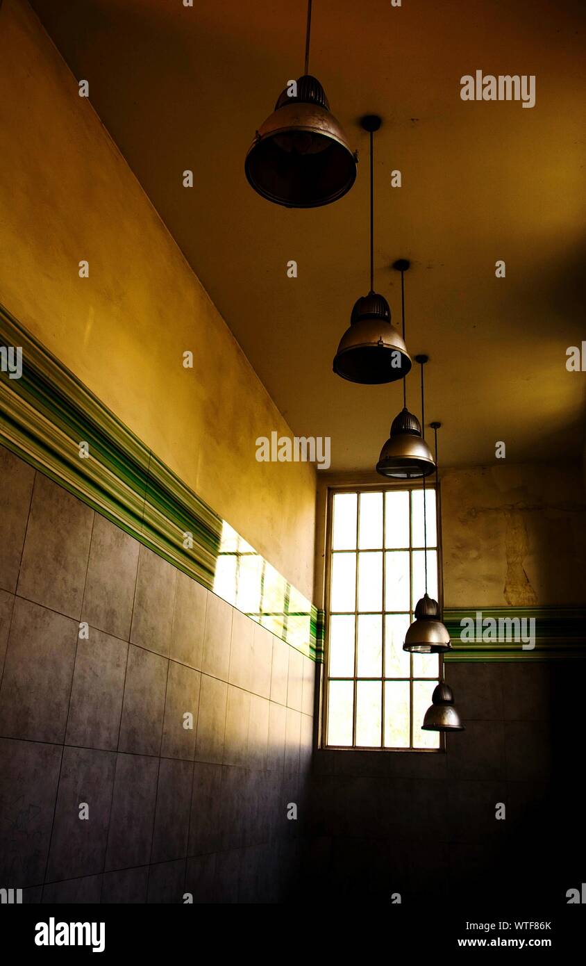 Low Angle View Of Pendant Lights Hanging From Ceiling Stock