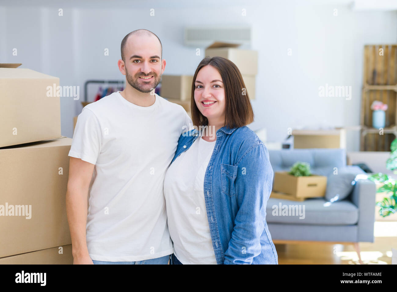 Young couple together smiling happy moving to a new house Stock Photo ...