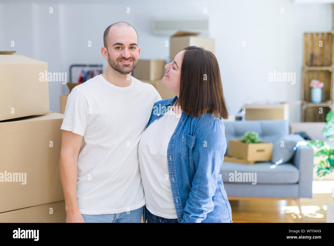 Young couple together smiling happy moving to a new house Stock Photo ...