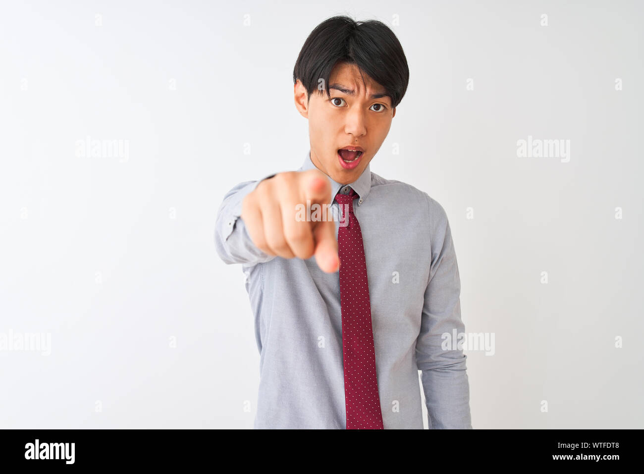 Chinese businessman wearing elegant tie standing over isolated white ...