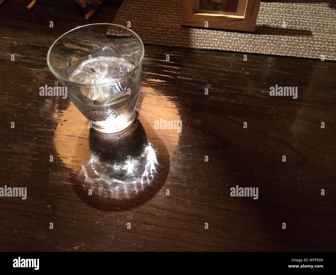 High Angle View Of Half Full Glass On Table Stock Photo