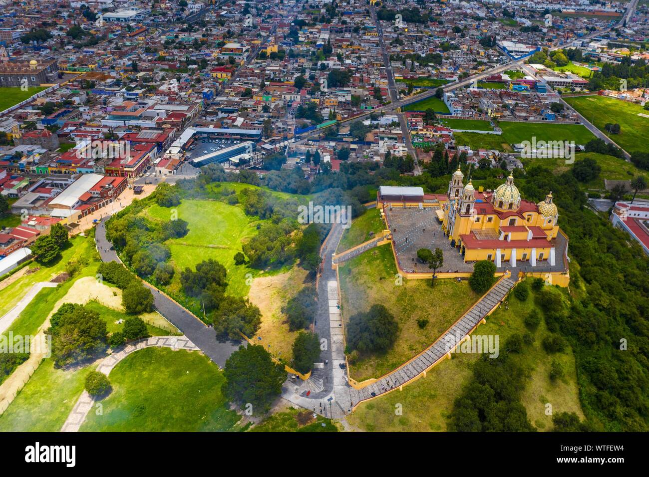 Aerial view of the Sanctuary of the Virgen de los Remedios in the Archaeological Zone of Cholula, Puebla, Mexico. Tlachihualtépetl. Puebla has Mexican traditions: gastronomic, colonial architecture and ceramics. Painted talavera tiles adorn ancient buildings. The cathedral of Puebla, in Renaissance style, has a high-rise bell tower overlooking the Zocalo, the central square or zocalo. I enter historical. Architecture is a UNESCO World Heritage Site. Attractions: Cathedral, Temple of Our Lady of Concord, Former Carolino College, Palafoxiana Library, Temple of Santo Domingo.  (© Photo: LuisGutie Stock Photo