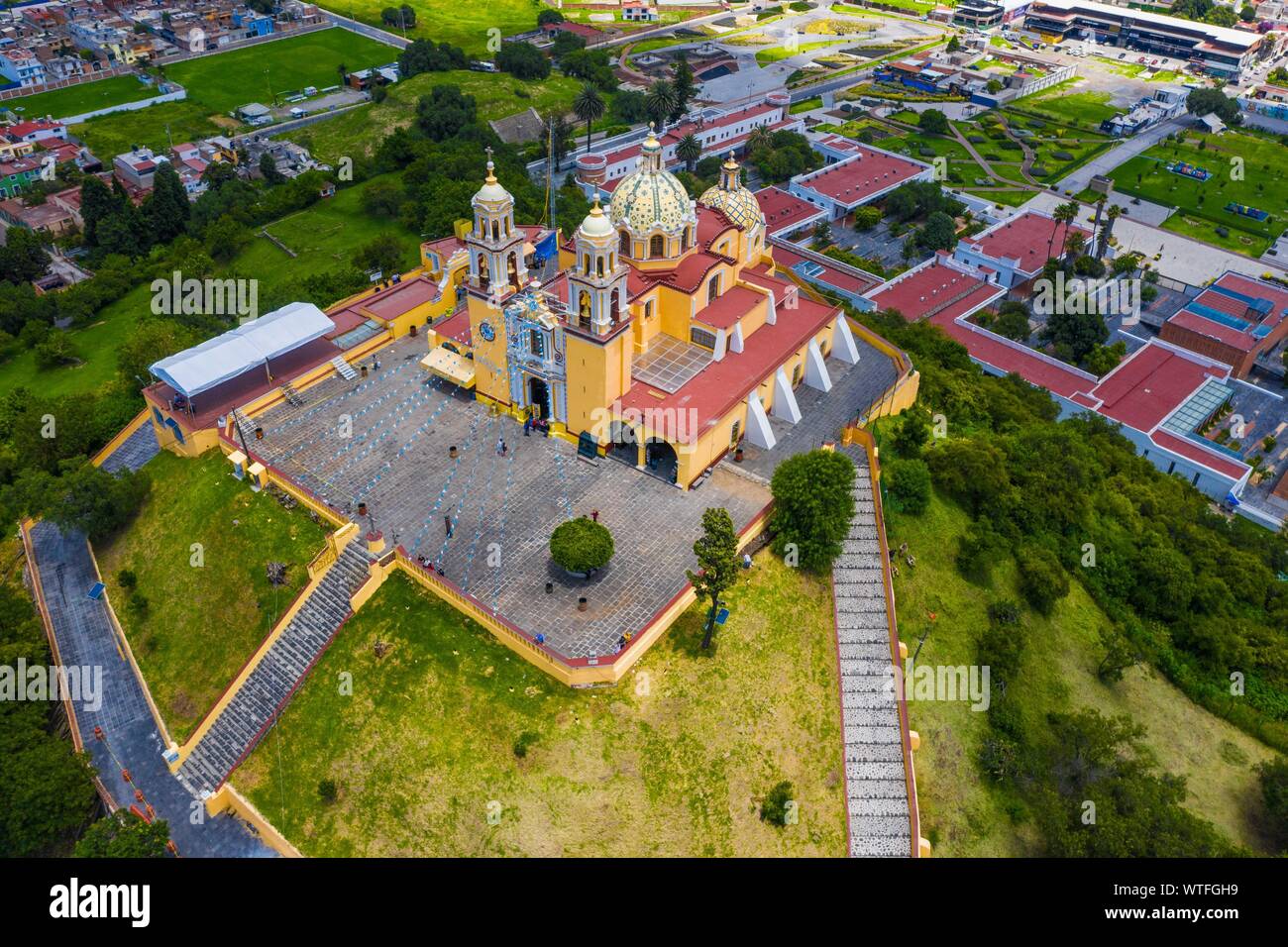 Aerial view of the Sanctuary of the Virgen de los Remedios in the Archaeological Zone of Cholula, Puebla, Mexico. Tlachihualtépetl. Puebla has Mexican traditions: gastronomic, colonial architecture and ceramics. Painted talavera tiles adorn ancient buildings. The cathedral of Puebla, in Renaissance style, has a high-rise bell tower overlooking the Zocalo, the central square or zocalo. I enter historical. Architecture is a UNESCO World Heritage Site. Attractions: Cathedral, Temple of Our Lady of Concord, Former Carolino College, Palafoxiana Library, Temple of Santo Domingo.  (© Photo: LuisGutie Stock Photo