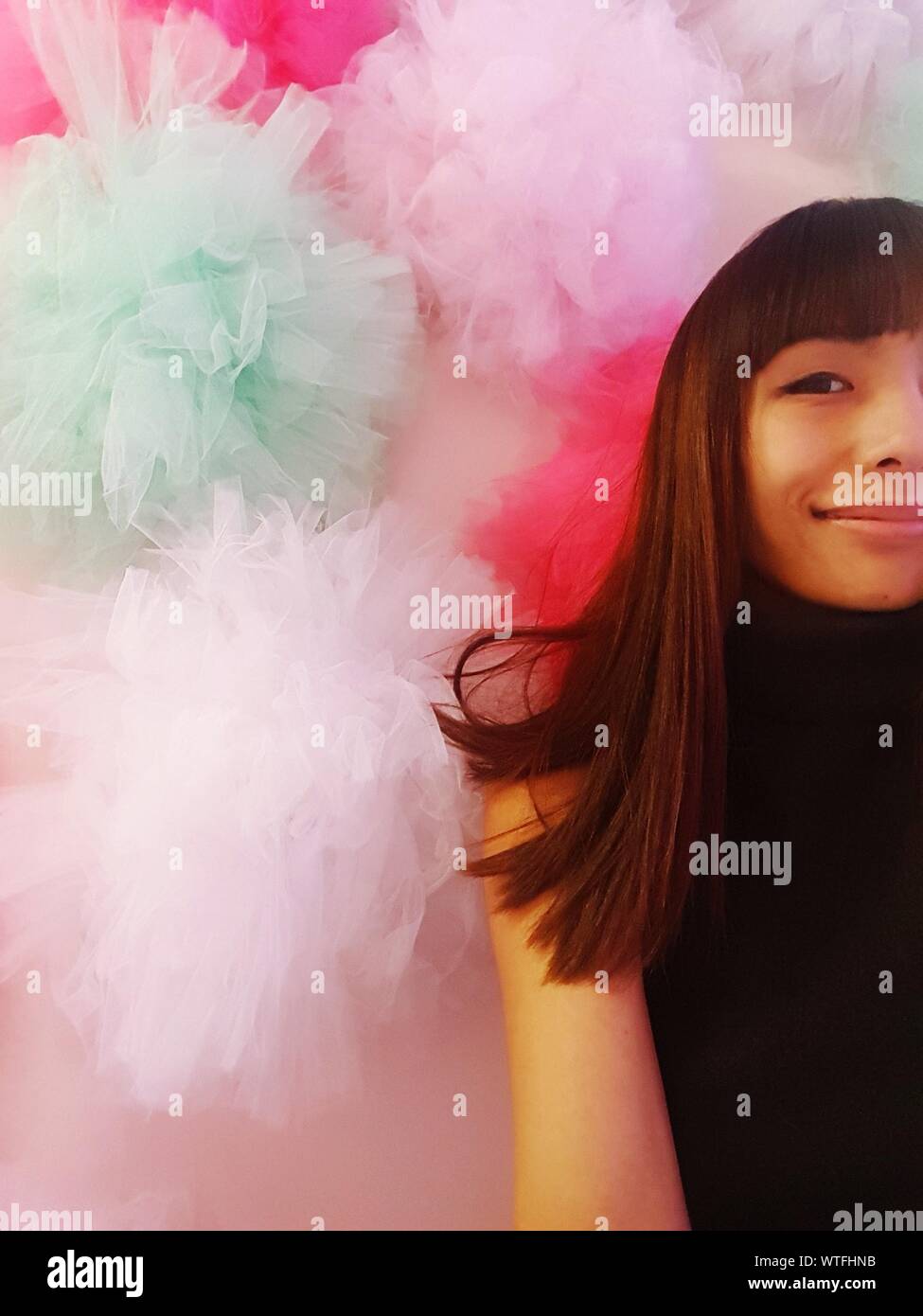 Portrait Of Smiling Young Woman By Tulle Netting Stock Photo