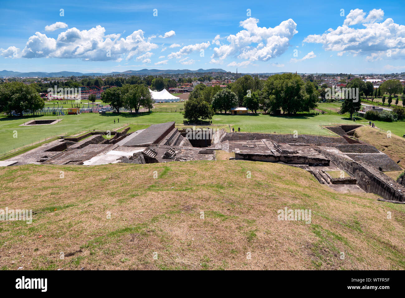 San Andres Cholula, Mexico, September 30, 2018 - High angle view of Great Pyramid of Cholula ruins with blue cloudy sky at sunny day. Stock Photo