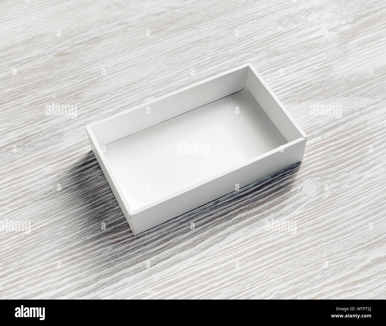 Blank white paper opened box on light wooden background. Stock Photo