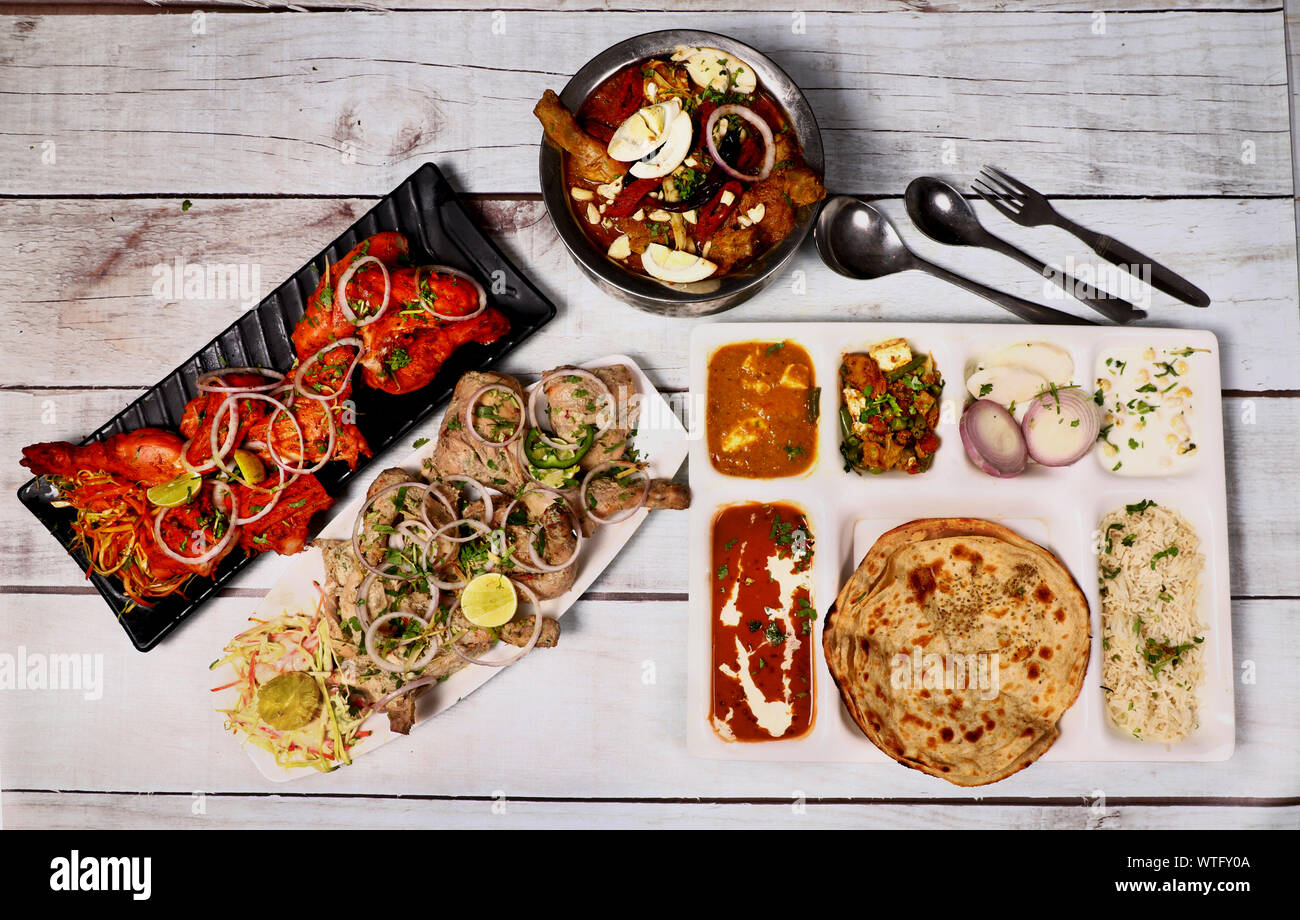 North Indian Food Combo Including Afghani chicken sahi paneer Rice Mix veg And Salad Stock Photo