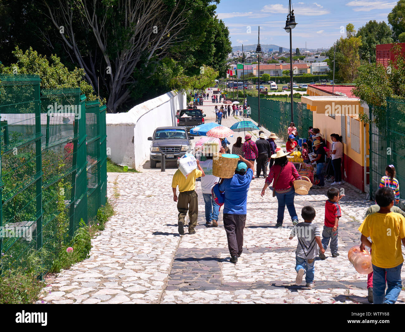 San Andres Cholula, Mexico, September 30, 2018 - People who work and tourists walk along the Calle 8 Pte street that descends from the Shrine of Our Lady of Remedies. Stock Photo