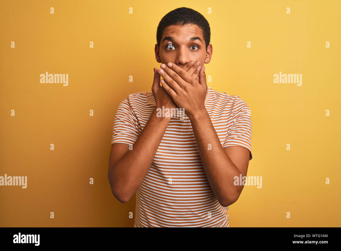 Young Handsome Arab Man Wearing Striped T Shirt Standing Over Isolated