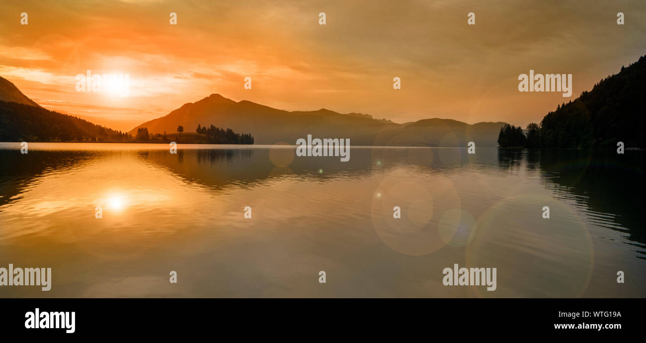 beautiful sunset at lake with mountain range Stock Photo - Alamy
