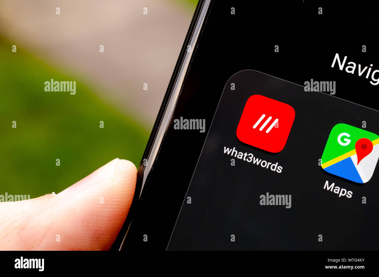 What3words app icon on the smartphone screen in the section of navigation apps, next to Google Maps. What 3 words is an innovative geocoding system. Stock Photo