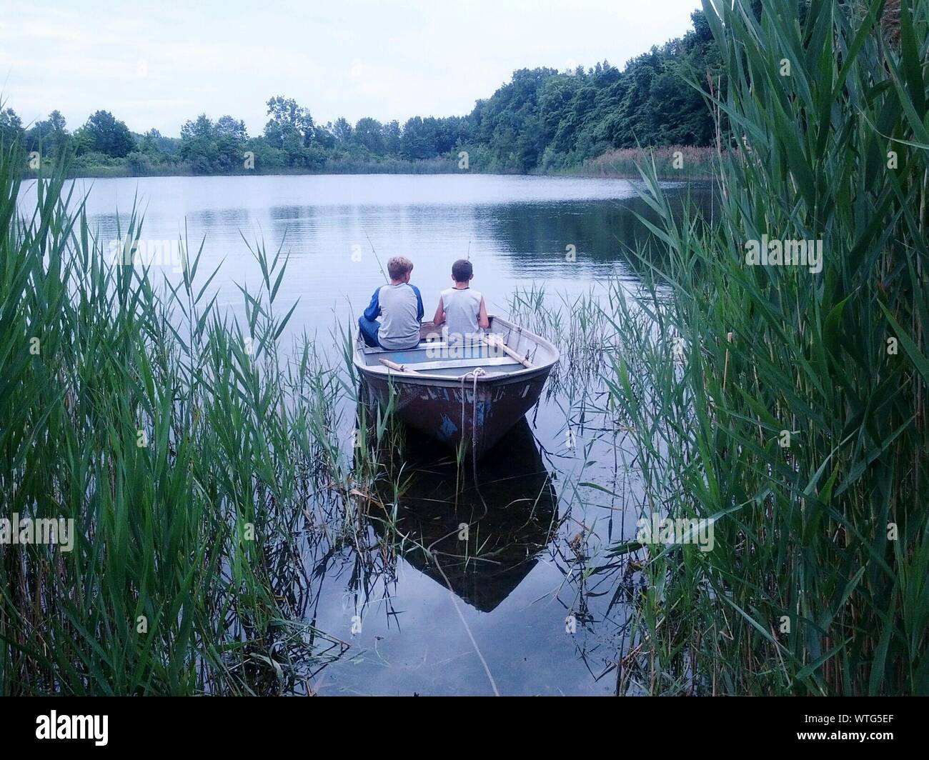 Two boys sitting fishing hi-res stock photography and images - Alamy