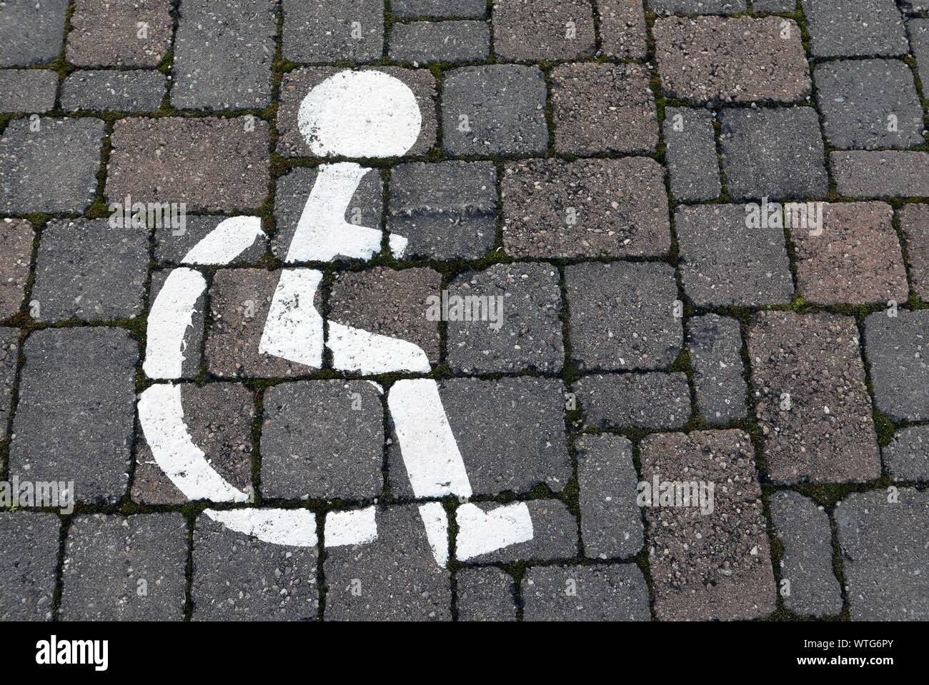 High Angle View Of Pedestrian Handicapped Sign On Road Stock Photo