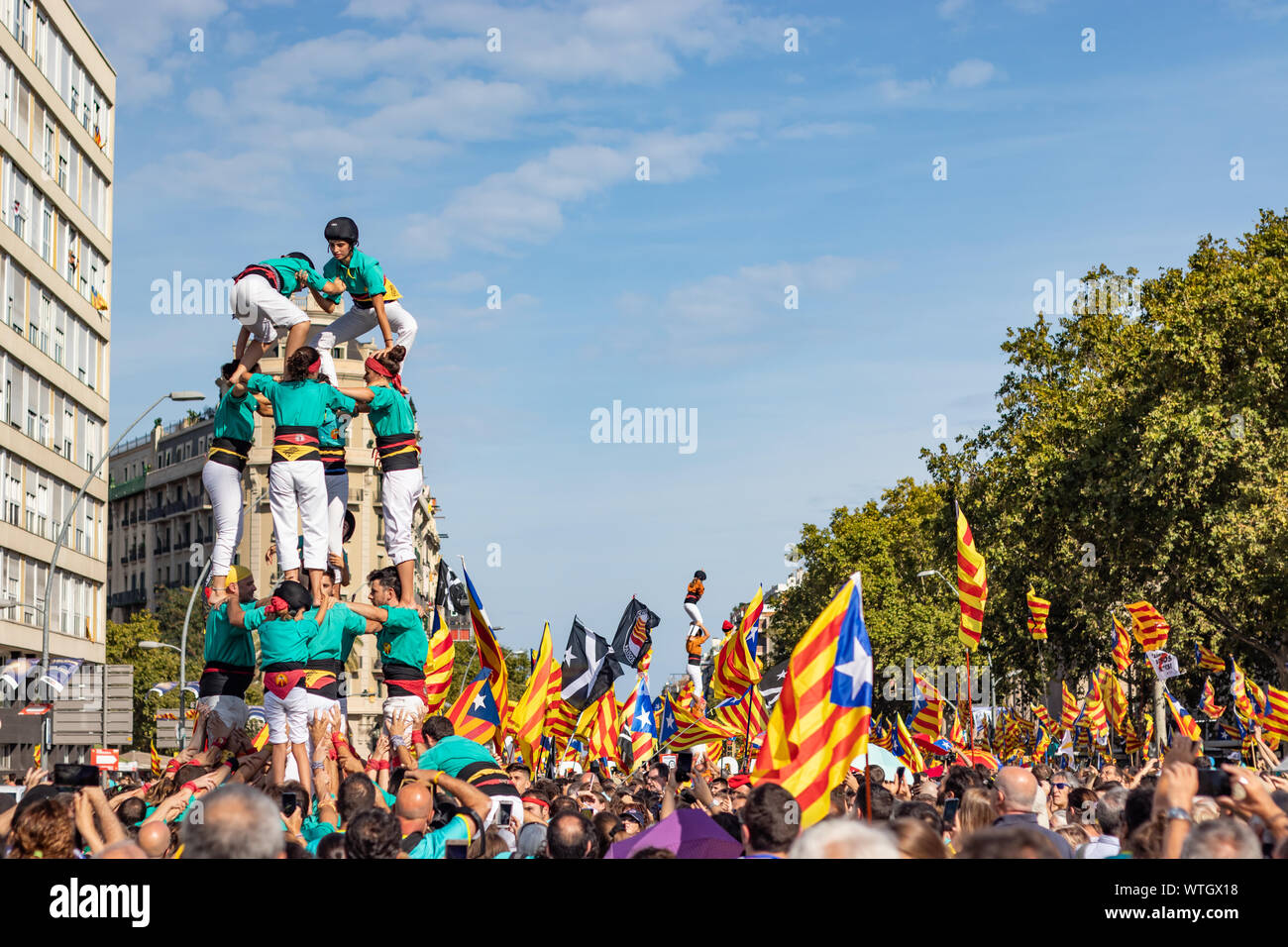 Young people during a 'Castellers' performance during an independentist rally. Traditional catalan sport based on creating human towers Stock Photo