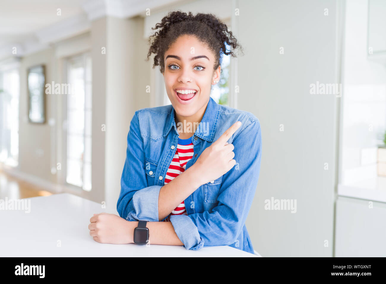 Beautiful young african american woman with afro hair wearing casual ...