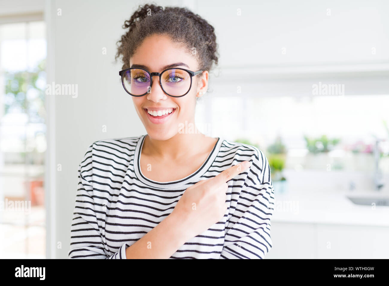 Beautiful young african american woman with afro hair wearing glasses ...
