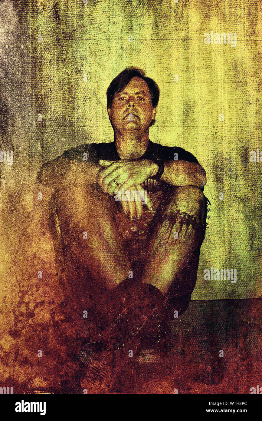Portrait Of Serious Mid Adult Man Sitting On Floor Stock Photo - Alamy