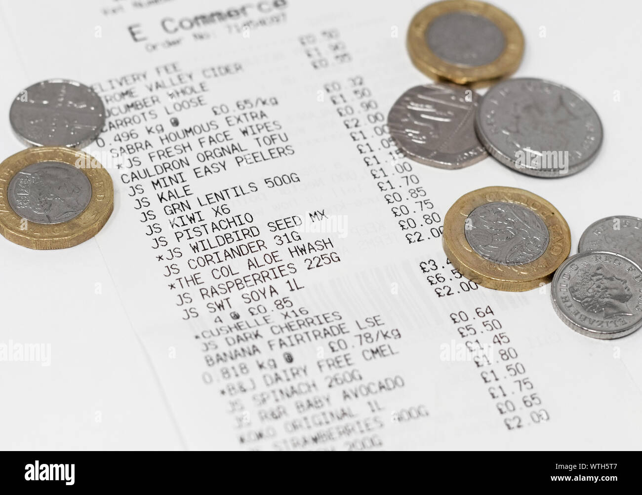 London / UK - September 9th 2019 - Grocery shopping receipt and money, closeup with a shallow depth of field Stock Photo