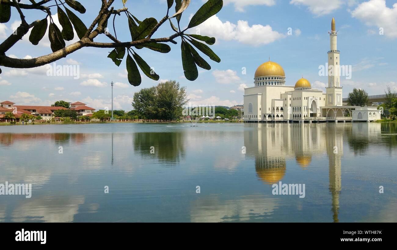 As-salam Mosque Of Lake Against Sky Stock Photo