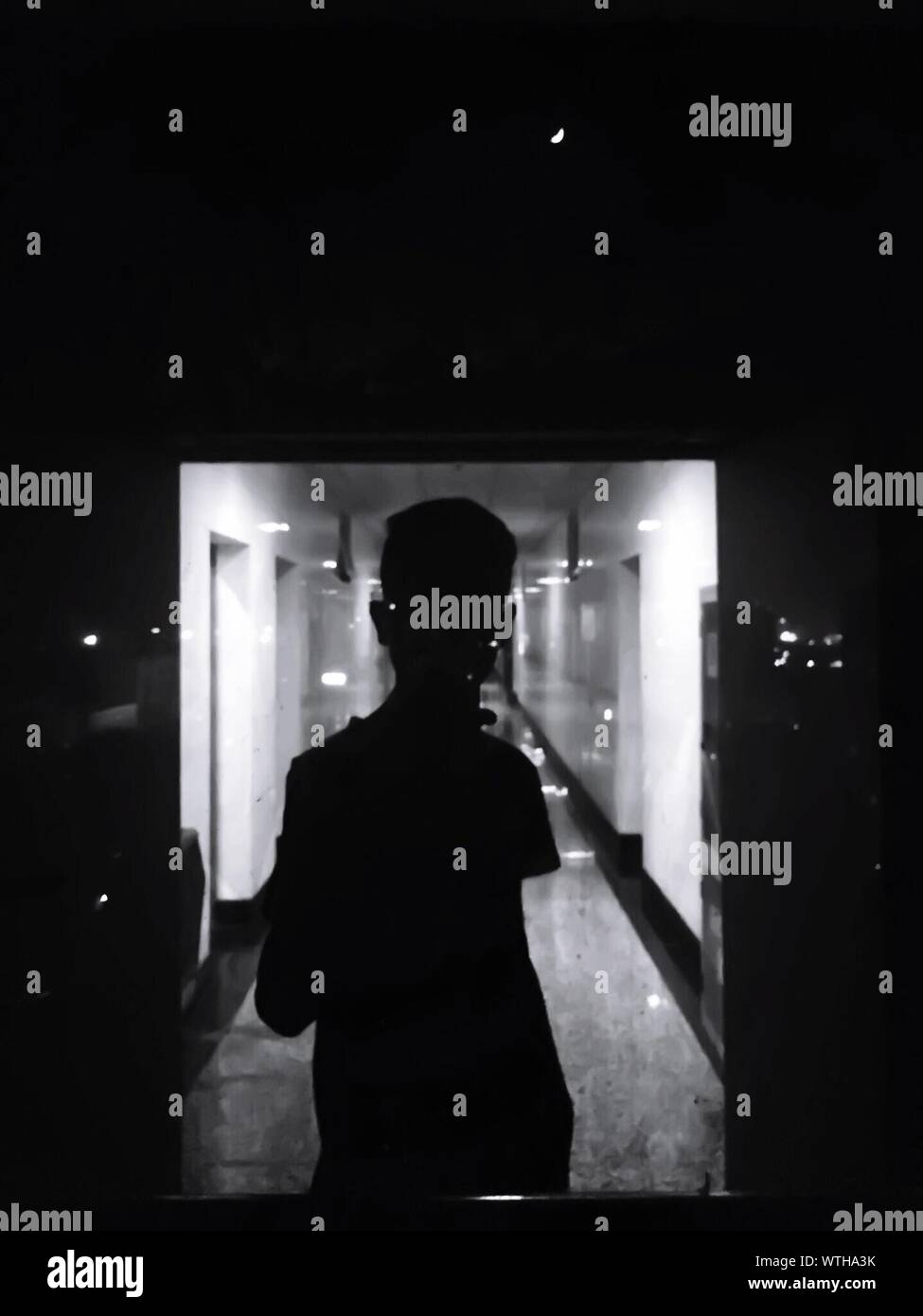 Reflection Of Man On Window Glass In Building Stock Photo