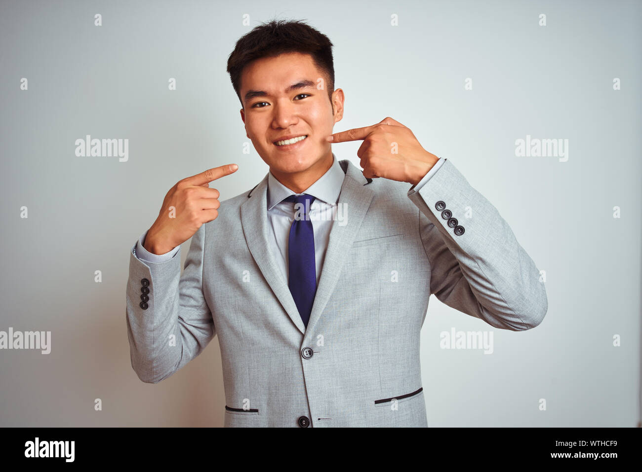 Asian chinese businessman wearing suit and tie standing over isolated ...