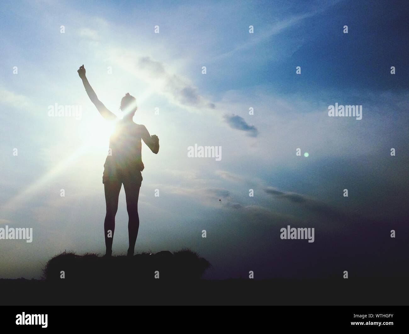 Silhouette Of Standing Woman Stock Photo