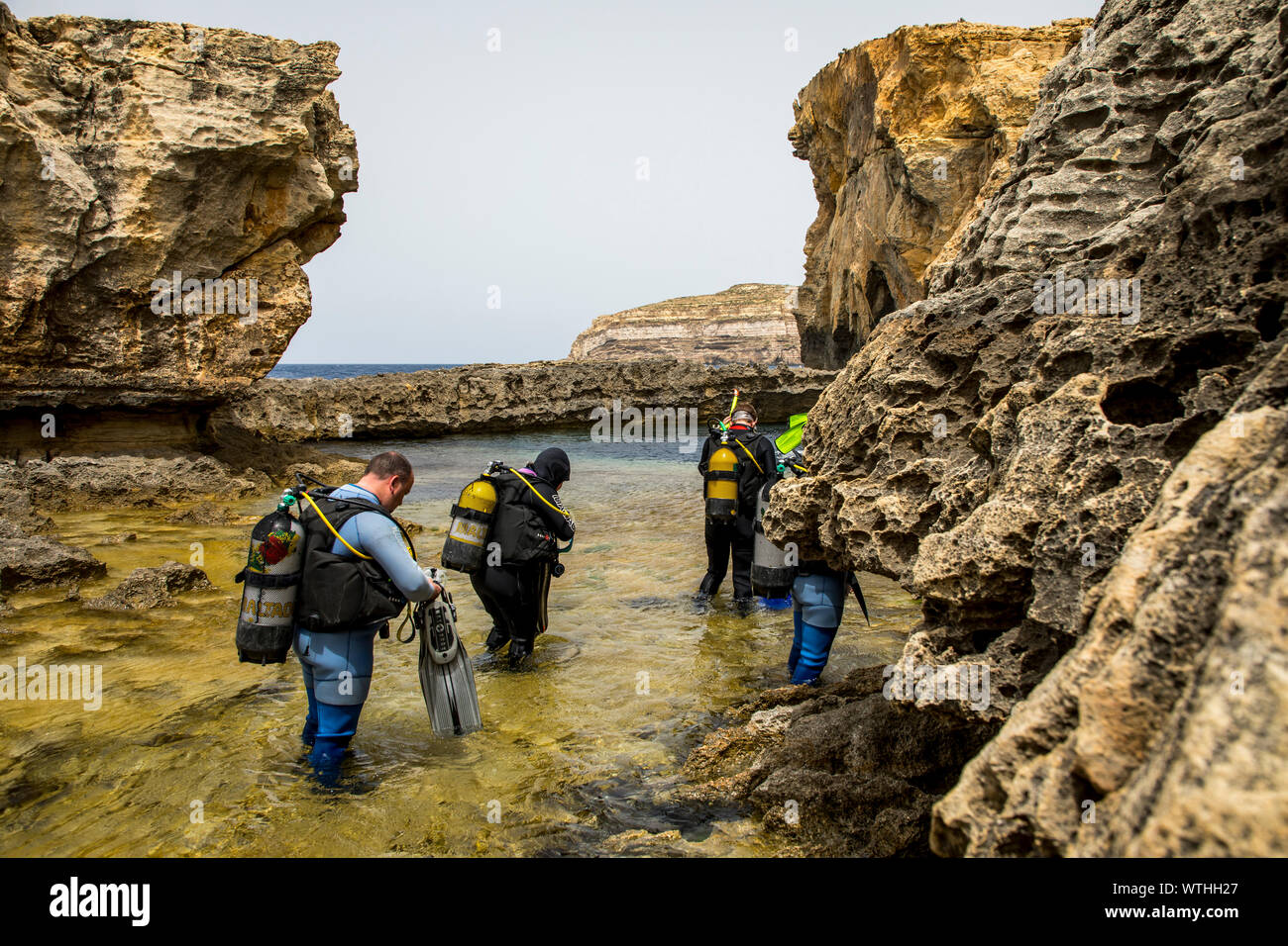 Gozo, neighbouring island of Malta, northwest coast, rocky coast, near San Lawrenz, near the former Azure Window, collapsed, diver on his way to the B Stock Photo
