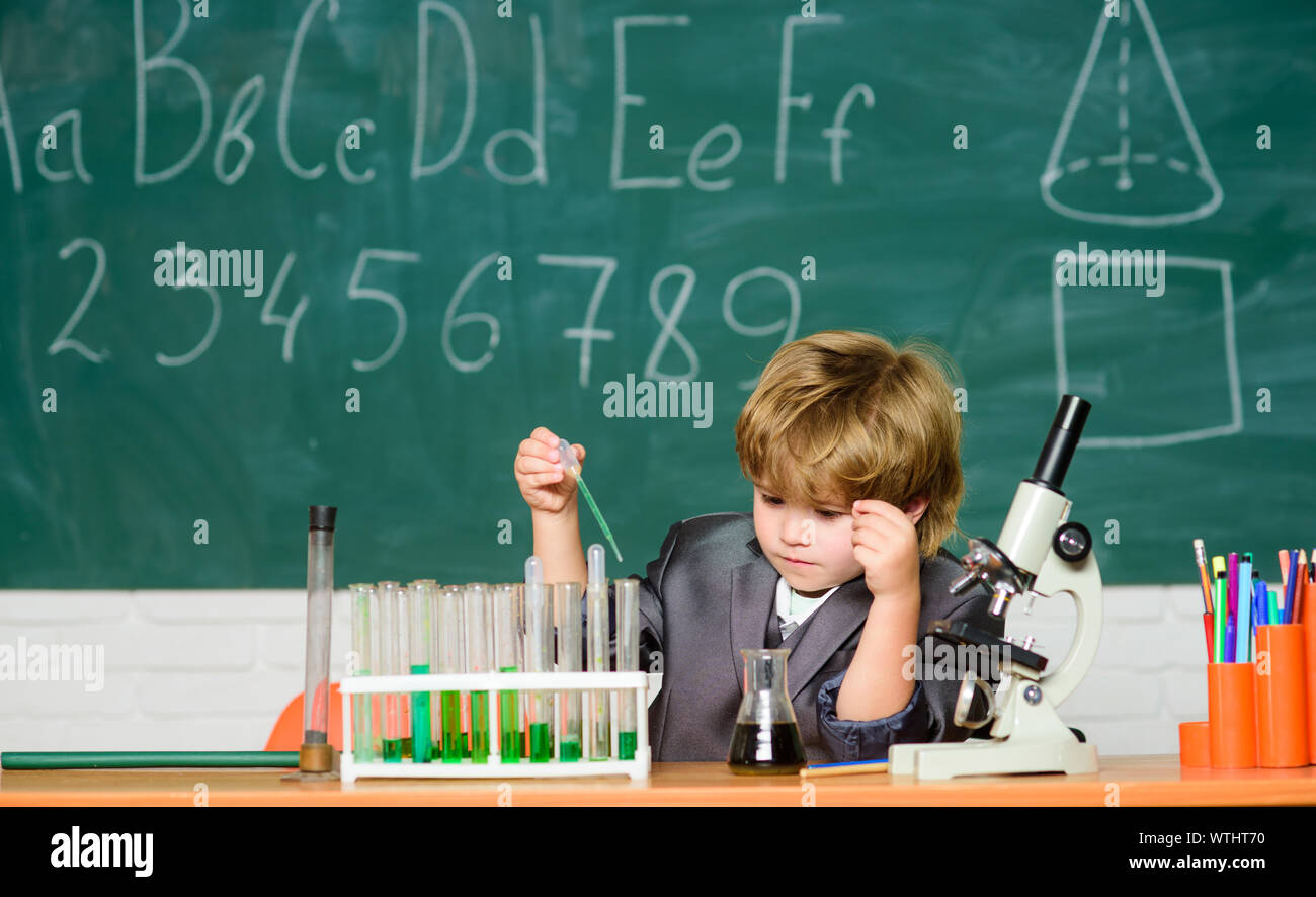 school kid scientist studying science. Little kid learning chemistry in
