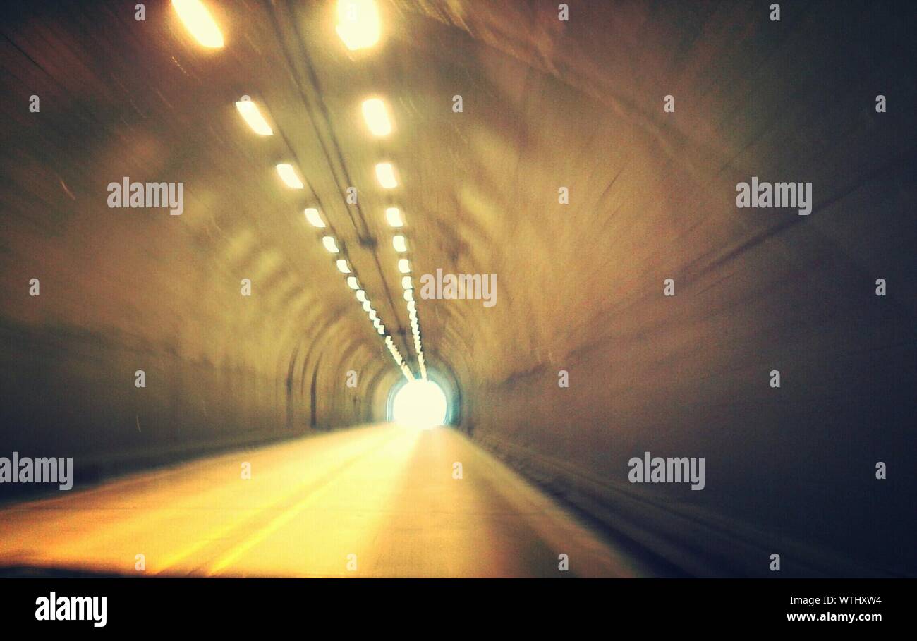 View Of Empty Road With Ceiling Lights At Tunnel Stock Photo