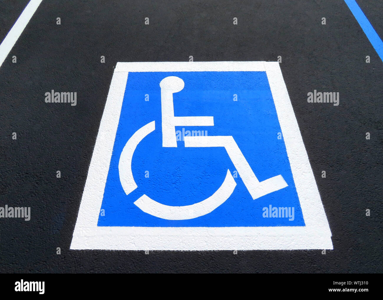 Freshly resurfaced and repainted handicap parking space in a parking