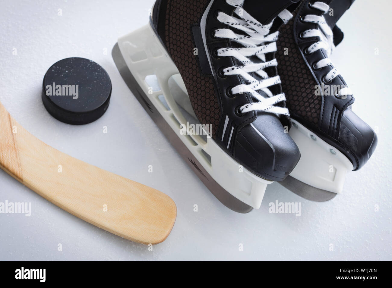 Ice skates with puck and stick Stock Photo Alamy