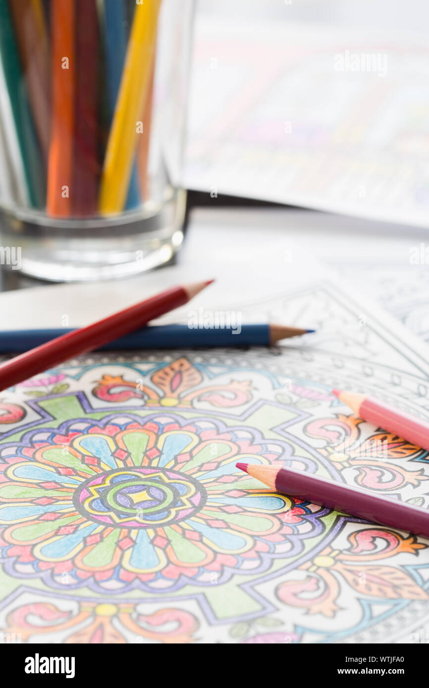 Colored pencils on coloring book page Stock Photo