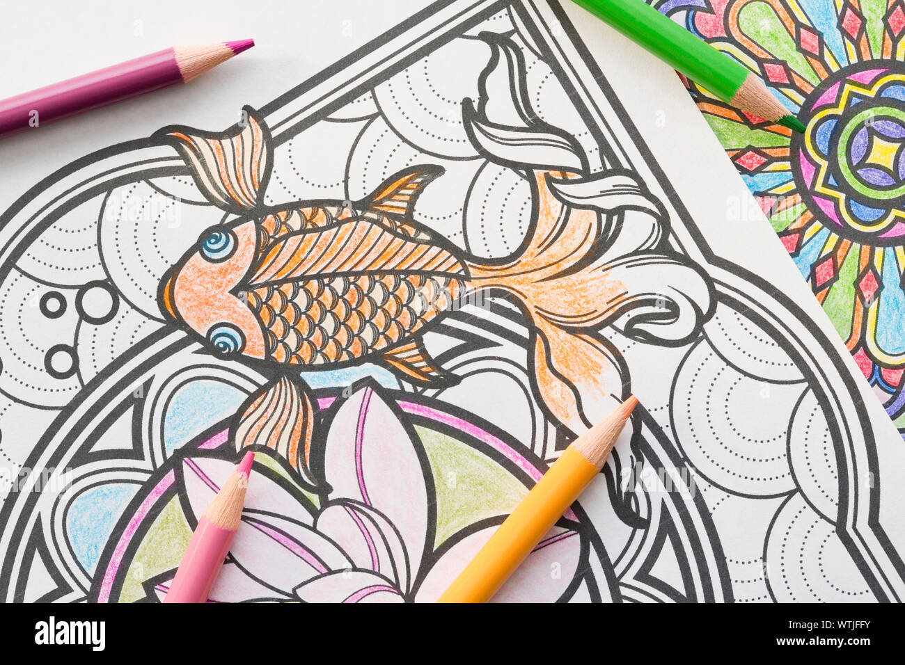 Colored pencils on coloring book page Stock Photo