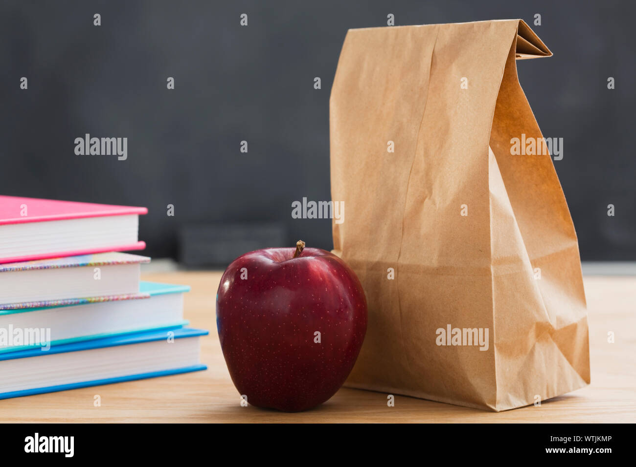 School meal in paper bag on desk Stock Photo
