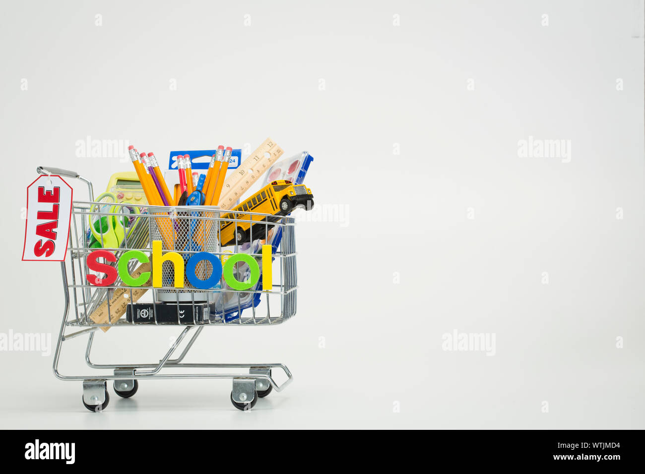 Premium Photo  Shopping carts with school supplies isolated on a